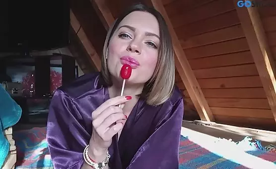 Spreading Her Legs and Tongue, Girl Passionately Licking Lollipop